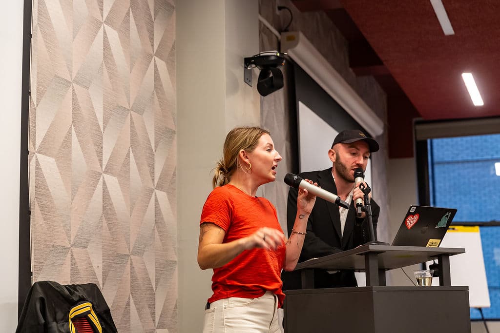 Nicole and Harry presenting together at the front of the room